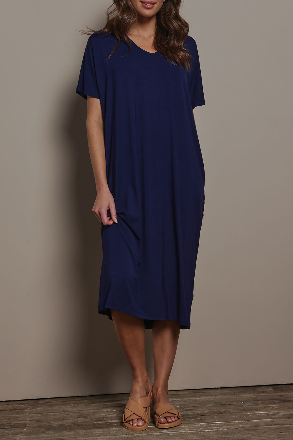 Model Madeline wearing size 10 of The Pack & Go Luxe Bamboo Pull On Dress with Pockets in colour Frenchnavy (Blue), from the front, cropped image