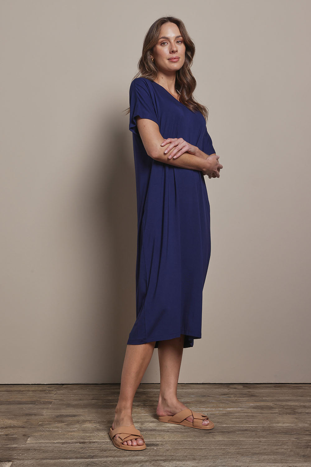 Model Madeline wearing size 10 of The Pack & Go Luxe Bamboo Pull On Dress with Pockets in colour Frenchnavy (Blue), from the front, showing the whole outfit