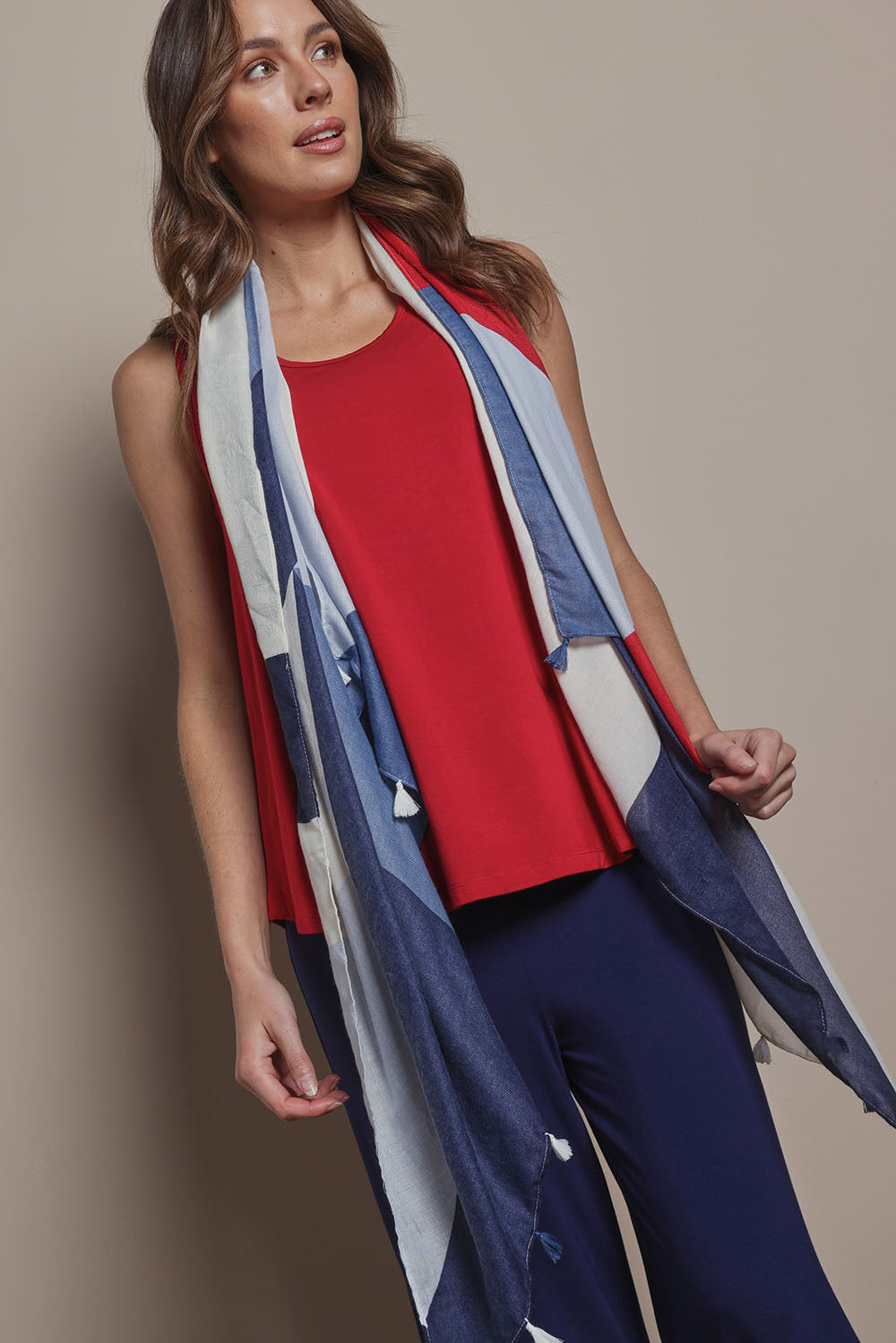 Model Madeline wearing size 10 of The Pack & Go Luxe Bamboo Swing Tank in colour Cherryred (Red), from the front, cropped image