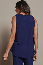 Model Amanda wearing size 10 of The Pack & Go Luxe Bamboo Swing Tank in colour Frenchnavy (Blue), from the back