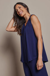 Model Amanda wearing size 10 of The Pack & Go Luxe Bamboo Swing Tank in colour Frenchnavy (Blue), from the front, cropped image