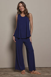 Model Madeline wearing size 10 of The Pack & Go Luxe Bamboo Swing Tank in colour Frenchnavy (Blue), from the front, showing the whole outfit