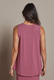 Model Amanda wearing size 10 of The Pack & Go Luxe Bamboo Swing Tank in colour Smokeyrose (Pink), from the back