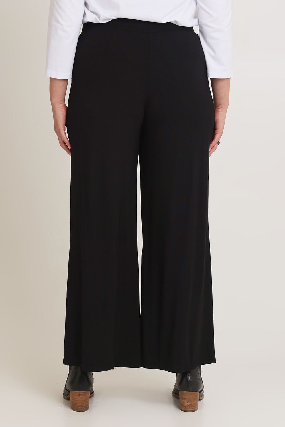 Model Chanel wearing size 16 of The Pack & Go Luxe Bamboo Wide Leg Pant in colour Black (Black), from the back