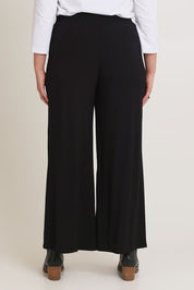 Model Chanel wearing size 16 of The Pack & Go Luxe Bamboo Wide Leg Pant in colour Black (Black), from the back
