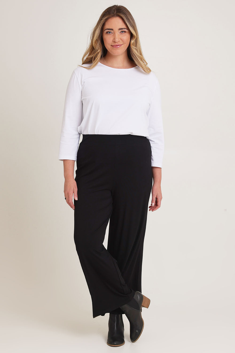 Model Chanel wearing size 16 of The Pack & Go Luxe Bamboo Wide Leg Pant in colour Black (Black), from the front, showing the whole outfit