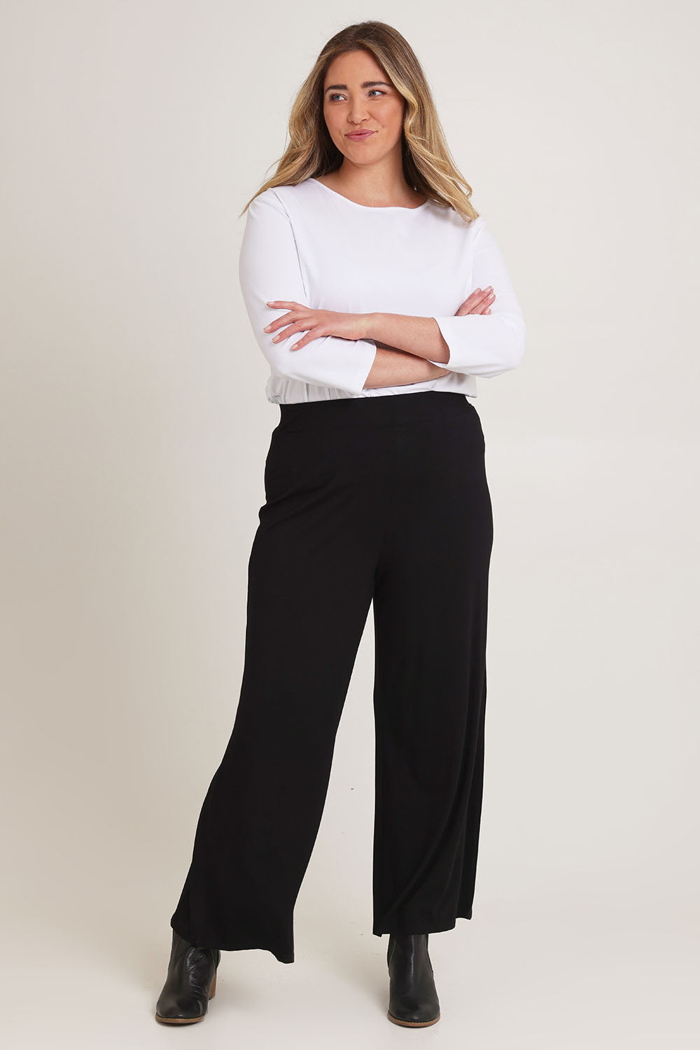 Model Chanel wearing size 16 of The Pack & Go Luxe Bamboo Wide Leg Pant in colour Black (Black), from the front, showing the whole outfit