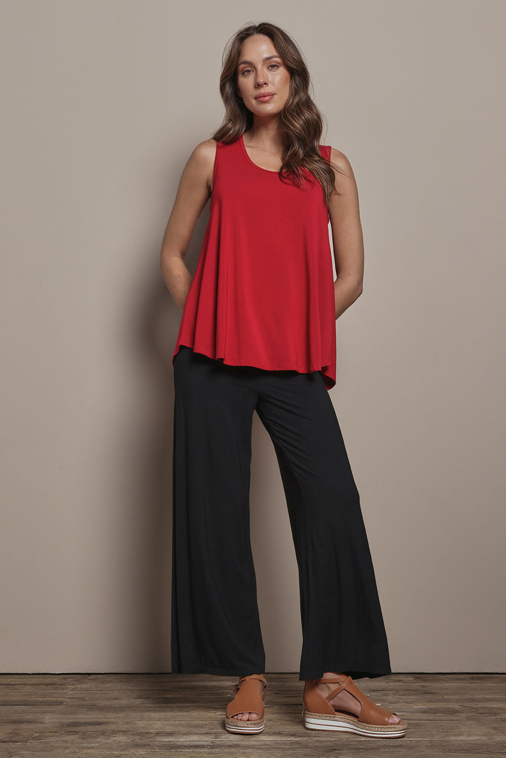 Model Madeline wearing size 10 of The Pack & Go Luxe Bamboo Wide Leg Pant in colour Black (Black), from the front, showing the whole outfit