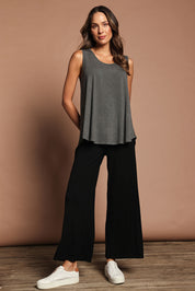 Model Madeline wearing size 10 of The Pack & Go Luxe Bamboo Wide Leg Pant in colour Black (Black), from the front, showing the whole outfit