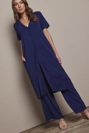 Model Madeline wearing size 10 of The Pack & Go Luxe Bamboo Wide Leg Pant in colour Frenchnavy (Blue), from the front, showing the whole outfit