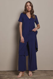 Model Madeline wearing size 10 of The Pack & Go Luxe Bamboo Wide Leg Pant in colour Frenchnavy (Blue), from the front, showing the whole outfit