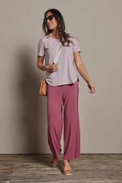 Model Amanda wearing size 10 of The Pack & Go Luxe Bamboo Wide Leg Pant in colour Smokeyrose (Pink), from the front, showing the whole outfit