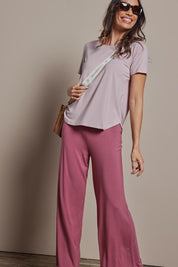 Model Amanda wearing size 10 of The Pack & Go Luxe Bamboo Wide Leg Pant in colour Smokeyrose (Pink), from the front, showing the whole outfit
