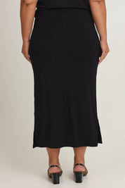 Model Ashleigh wearing size 16 of The Pack & Go Luxe Bamboo Pull On Maxi Skirt in colour Black (Black), from the back