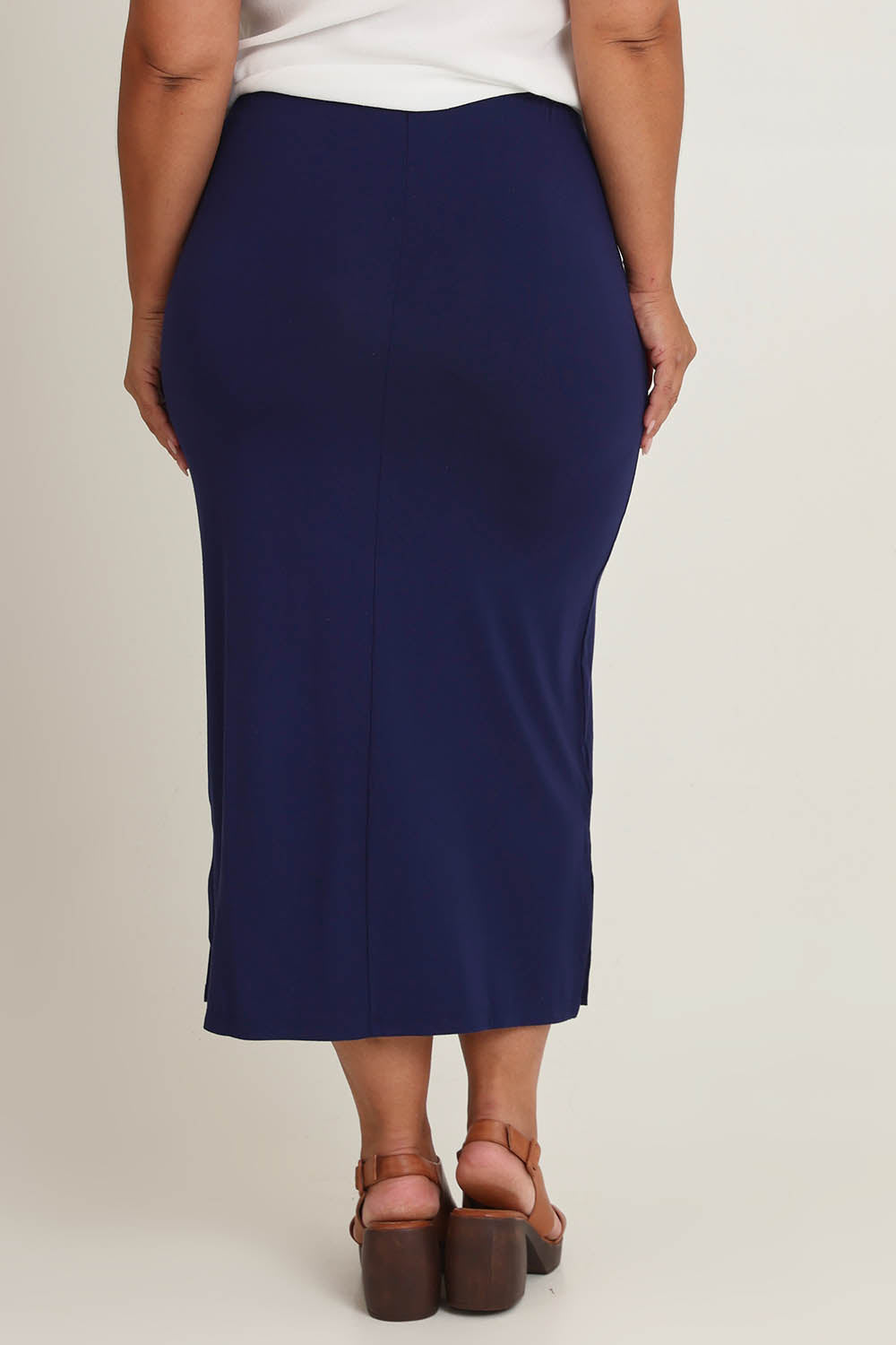Model Ashleigh wearing size 16 of The Pack & Go Luxe Bamboo Pull On Maxi Skirt in colour Frenchnavy (Blue), from the back