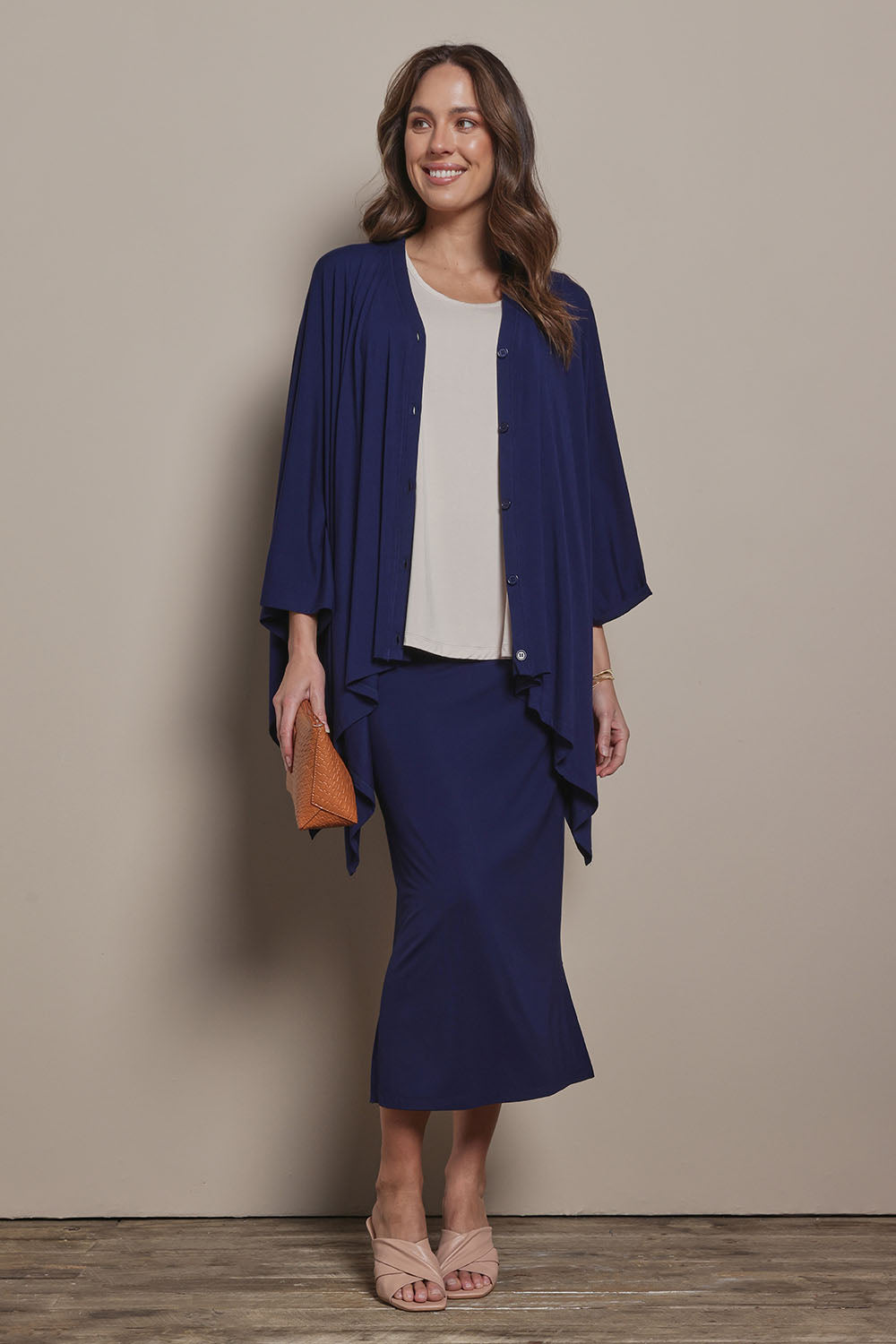 Model Madeline wearing size 10 of The Pack & Go Luxe Bamboo Pull On Maxi Skirt in colour Frenchnavy (Blue), from the front, showing the whole outfit