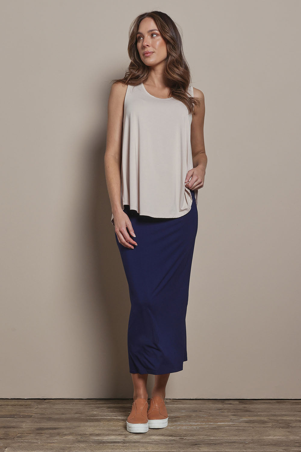 Model Madeline wearing size 10 of The Pack & Go Luxe Bamboo Pull On Maxi Skirt in colour Frenchnavy (Blue), from the front, showing the whole outfit