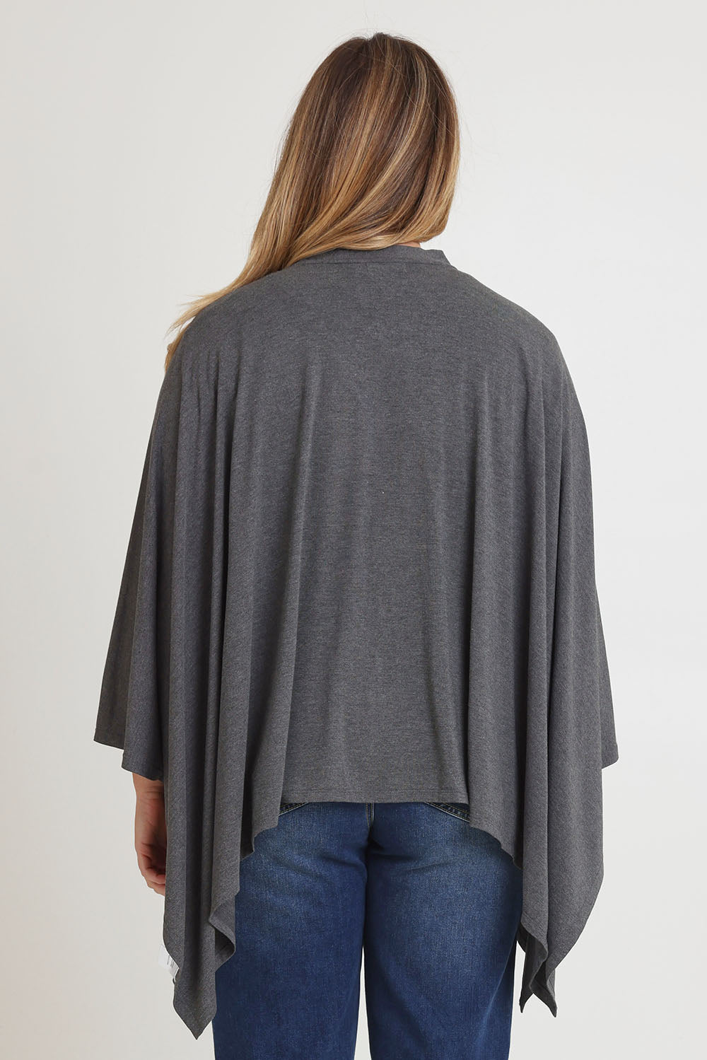 Model Chanel wearing The Pack & Go Luxe Bamboo Shrug in colour Charcoal (Grey), from the back