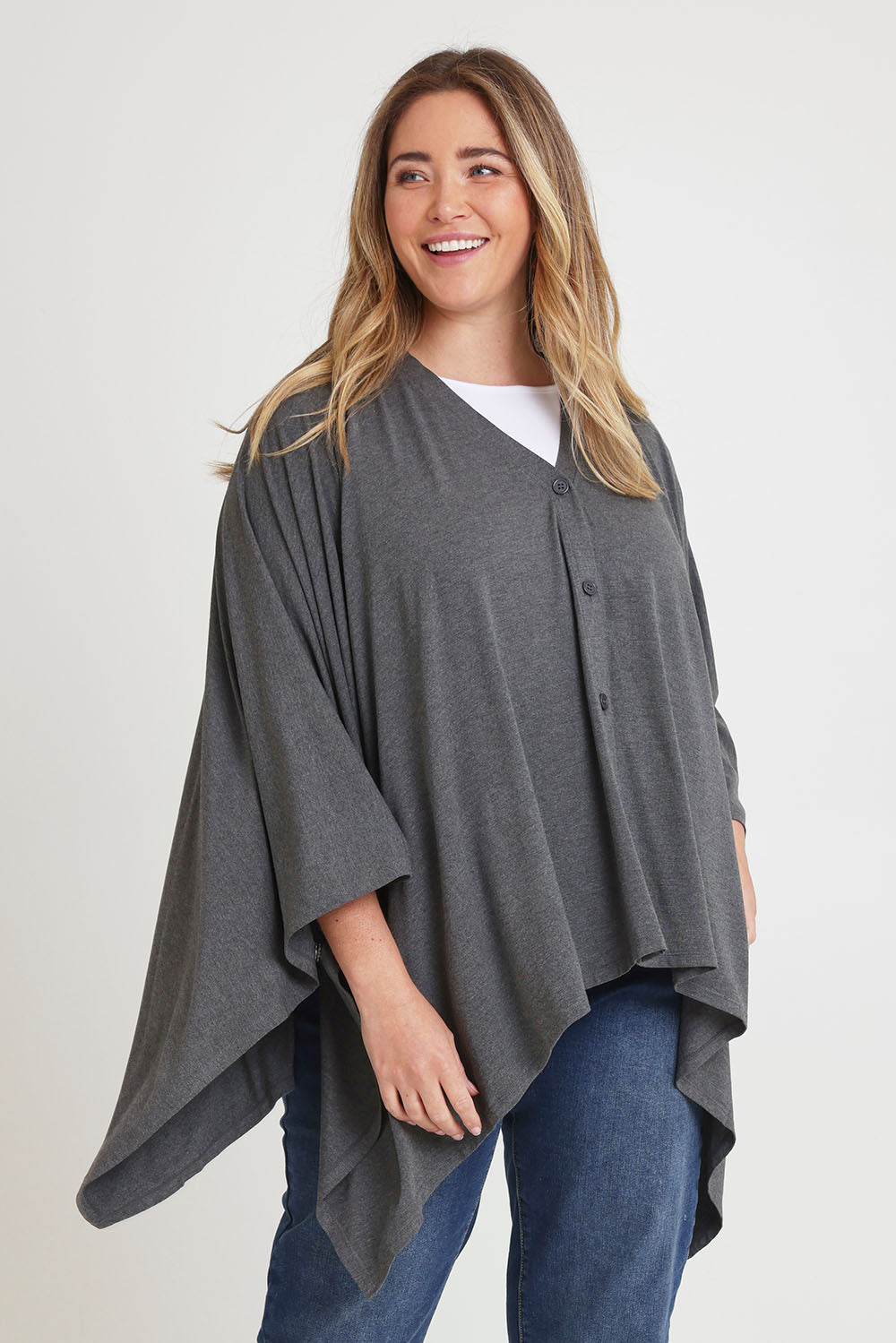 Model Chanel wearing The Pack & Go Luxe Bamboo Shrug in colour Charcoal (Grey), from the front, cropped image