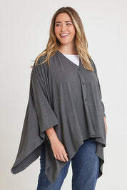 Model Chanel wearing The Pack & Go Luxe Bamboo Shrug in colour Charcoal (Grey), from the front, cropped image