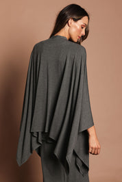 Model Madeline wearing The Pack & Go Luxe Bamboo Shrug in colour Charcoal (Grey), from the back
