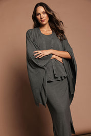 Model Madeline wearing The Pack & Go Luxe Bamboo Shrug in colour Charcoal (Grey), from the front, showing the whole outfit