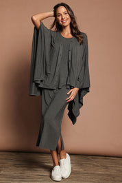 Model Madeline wearing The Pack & Go Luxe Bamboo Shrug in colour Charcoal (Grey), from the front, showing the whole outfit