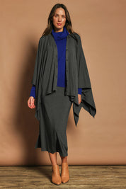 Model Madeline wearing The Pack & Go Luxe Bamboo Shrug in colour Charcoal (Grey), from the front, showing the whole outfit