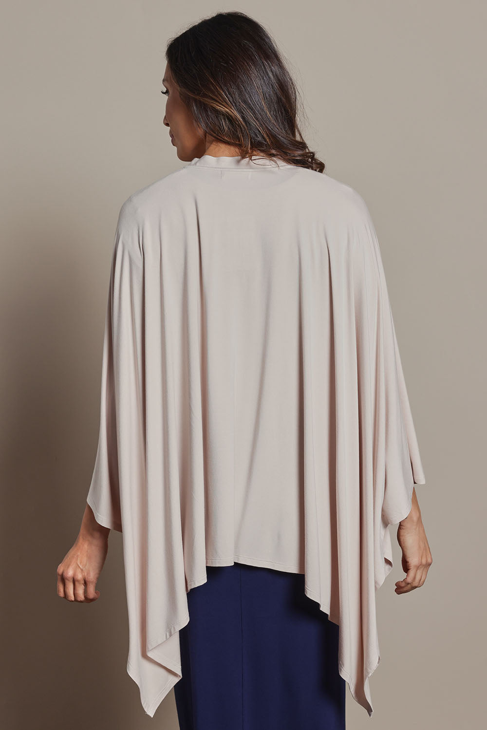 Model Amanda wearing The Pack & Go Luxe Bamboo Shrug in colour Nougat, from the back