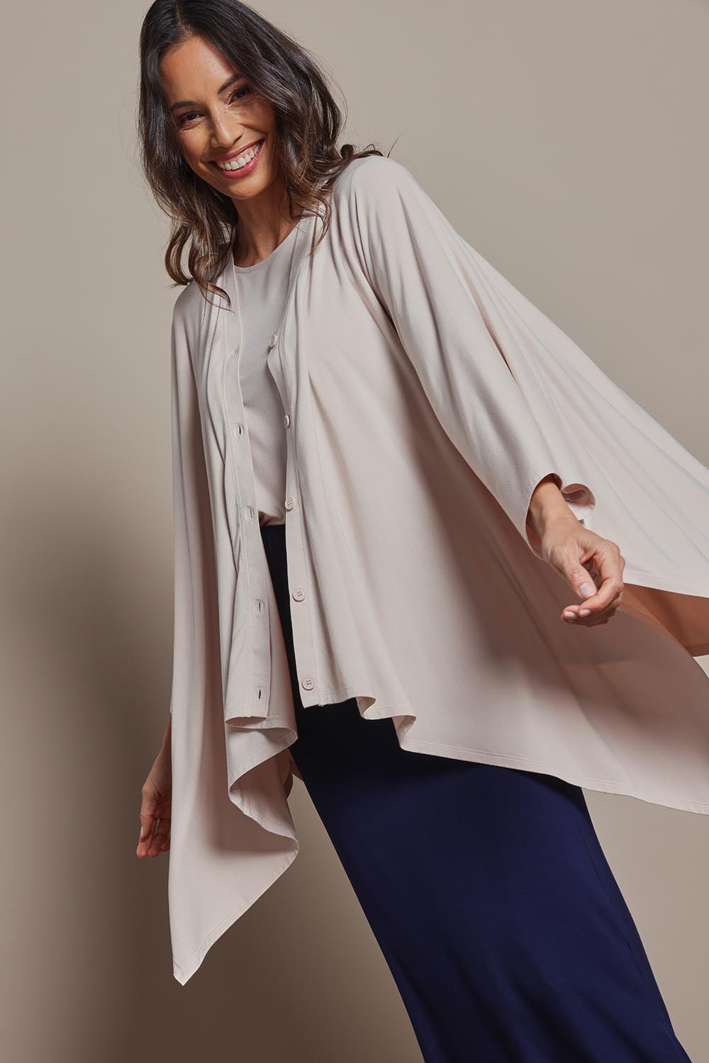 Model Amanda wearing The Pack & Go Luxe Bamboo Shrug in colour Nougat, from the front, cropped image