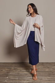 Model Amanda wearing The Pack & Go Luxe Bamboo Shrug in colour Nougat, from the front, showing the whole outfit