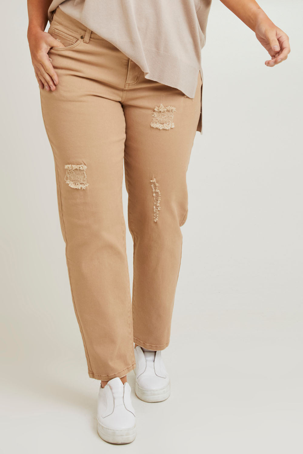Model Laura wearing size 14 of The Distressed Coloured Jean in colour Sand, from the front, cropped image