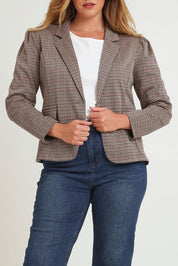 Model Chanel wearing size 16 of The Classic Houndstooth Blazer in colour Tanblack, from the front, cropped image