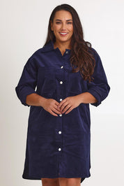Model Ashleigh wearing size 16 of The Cord Shacket Dress With Pockets in colour Darknavy (Blue), from the front, cropped image