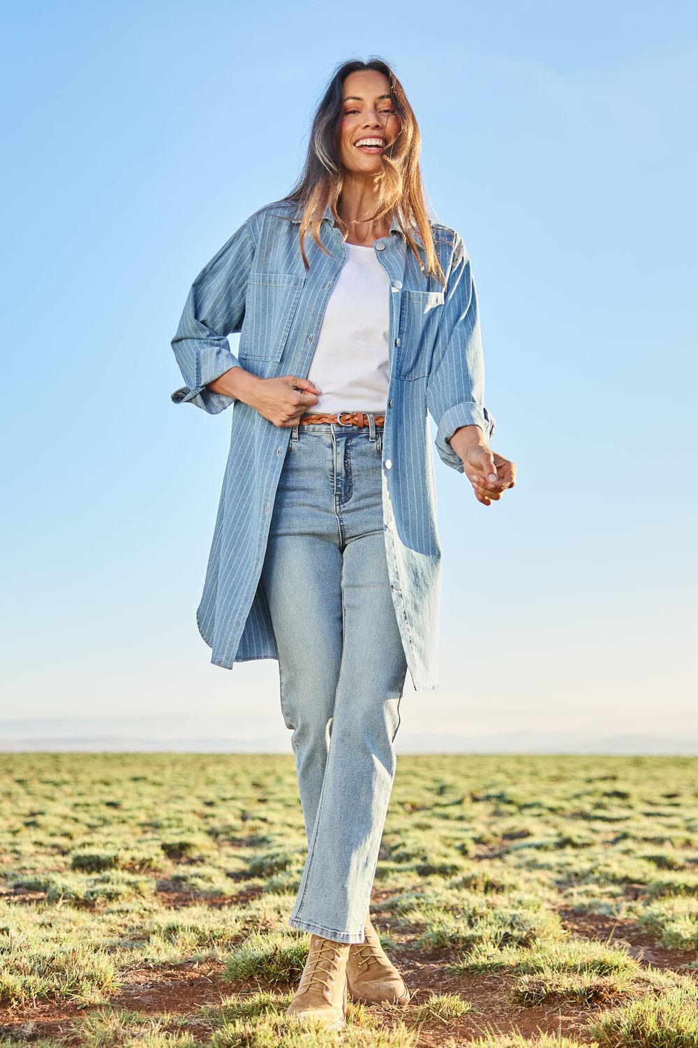 Model Amandam wearing size 10 of the The Printed Denim Shacket Dress With Pockets - Denimstrip in colour Denimstrip, from the front