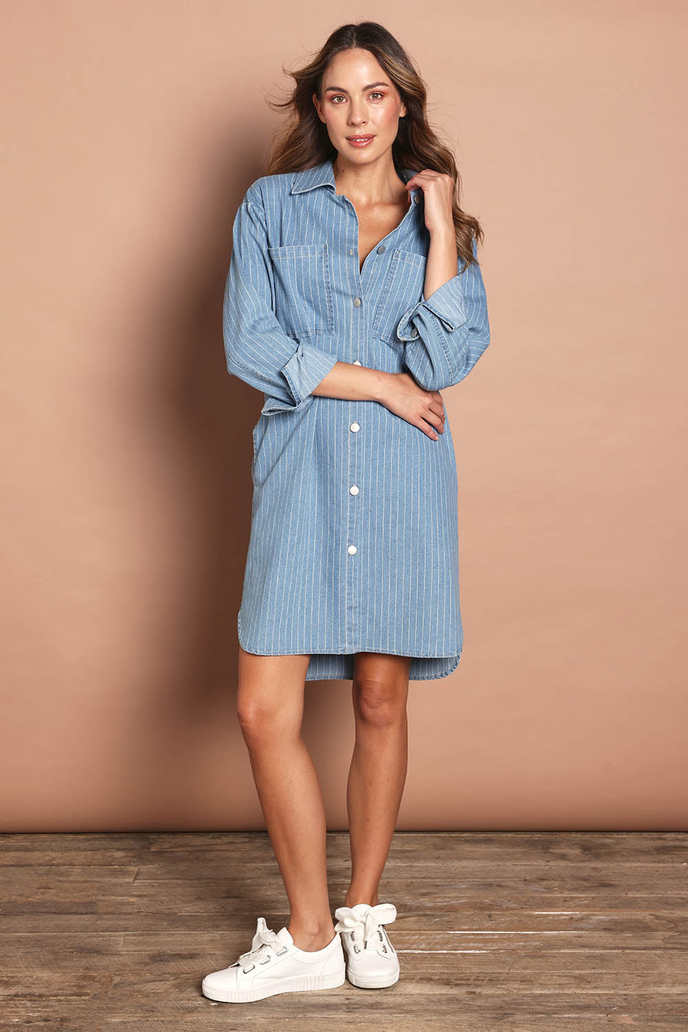 Model Madeline wearing size 10 of The Printed Denim Shacket Dress With Pockets in colour Denimstrip (Blue), from the front, showing the whole outfit