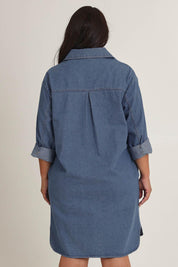 Model Ashleighf wearing size 16 of the The Denim Shacket Dress With Pockets - Denimblue in colour Denimblue, from the back
