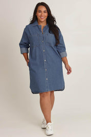 Model Ashleighf wearing size 16 of the The Denim Shacket Dress With Pockets - Denimblue in colour Denimblue, from the front