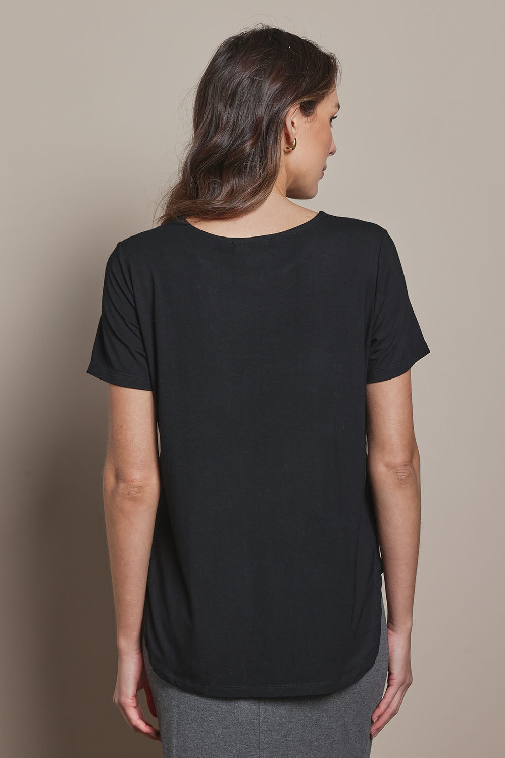 Model Madeline wearing size 10 of The Pack & Go Luxe Bamboo Tee in colour Black (Black), from the back