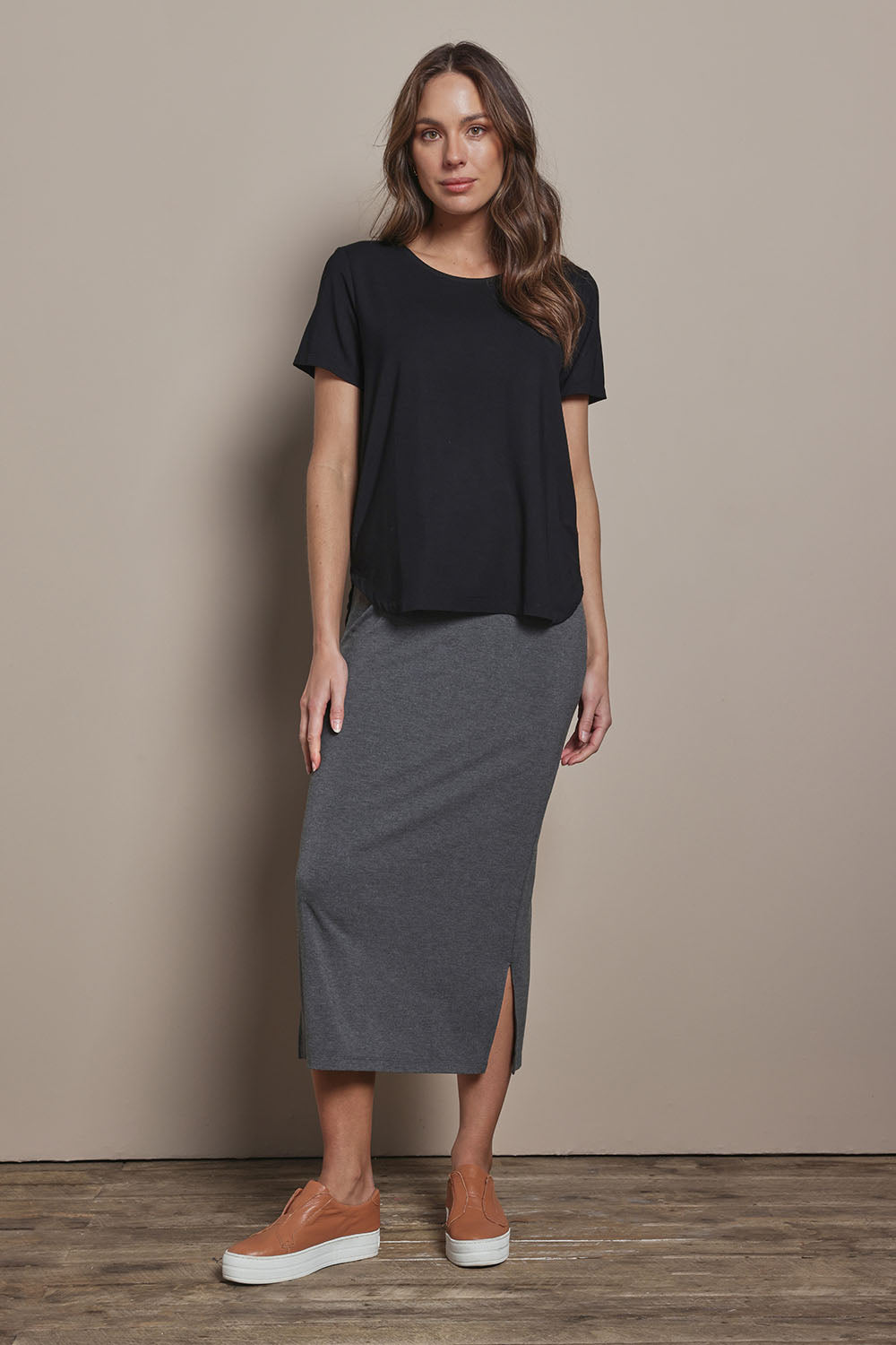 Model Madeline wearing size 10 of The Pack & Go Luxe Bamboo Tee in colour Black (Black), from the front, showing the whole outfit