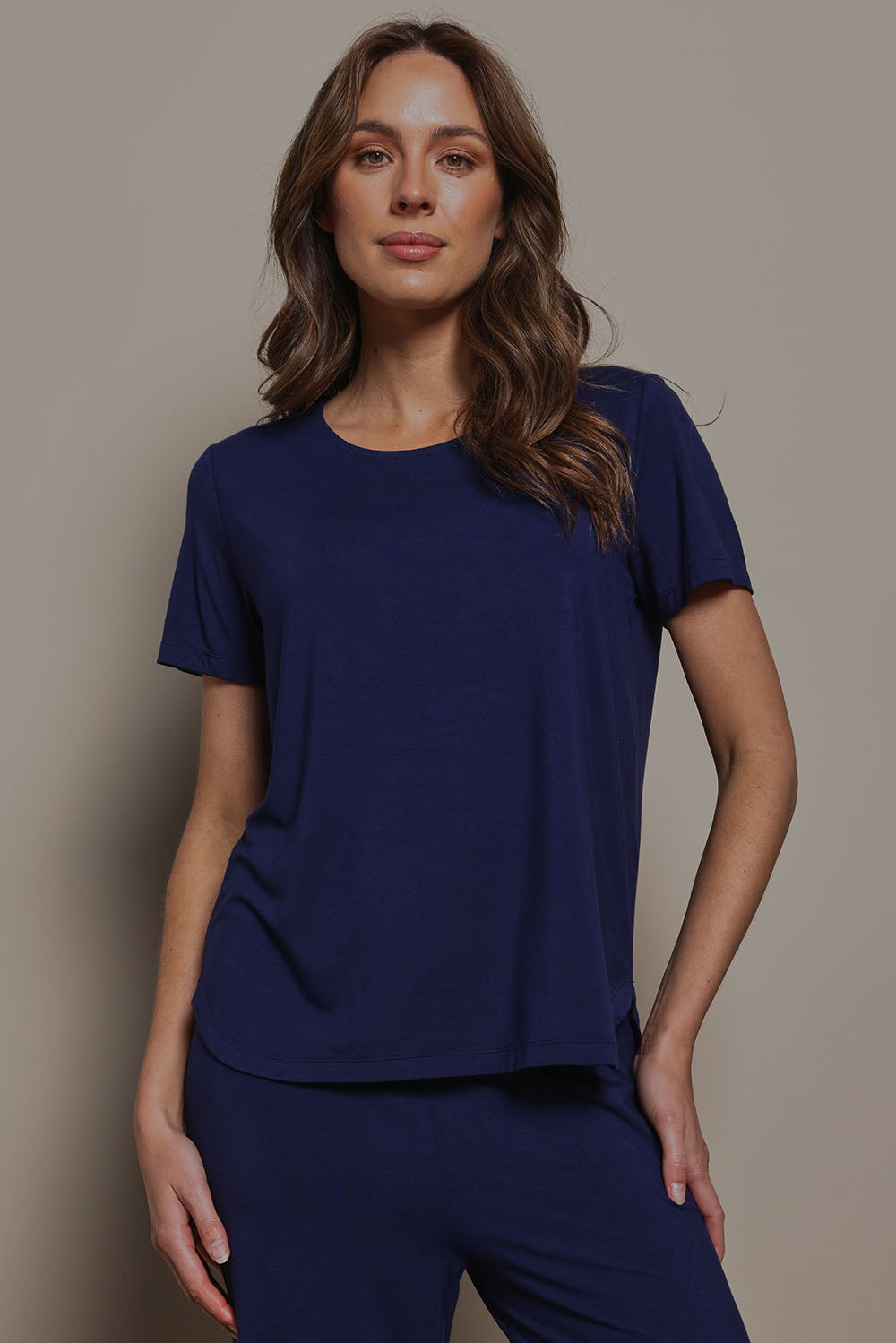 Model Madeline wearing size 10 of The Pack & Go Luxe Bamboo Tee in colour Frenchnavy (Blue), from the front, cropped image