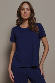 Model Madeline wearing size 10 of The Pack & Go Luxe Bamboo Tee in colour Frenchnavy (Blue), from the front, cropped image