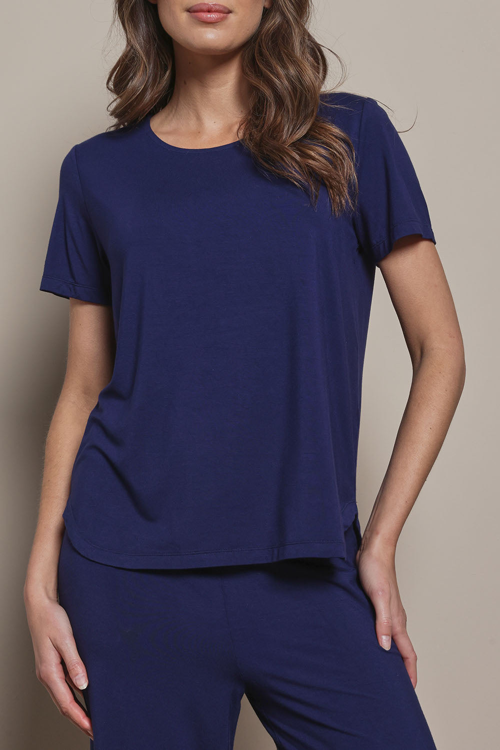 Model Madeline wearing size 10 of The Pack & Go Luxe Bamboo Tee in colour Frenchnavy (Blue), from the front, cropped image
