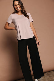 Model Madeline wearing size 10 of The Pack & Go Luxe Bamboo Tee in colour Roseblush (Pink), from the front, showing the whole outfit