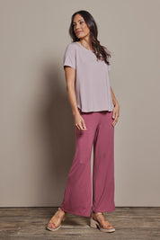 Model Monique wearing size 10 of The Pack & Go Luxe Bamboo Tee in colour Roseblush (Pink), from the front, showing the whole outfit