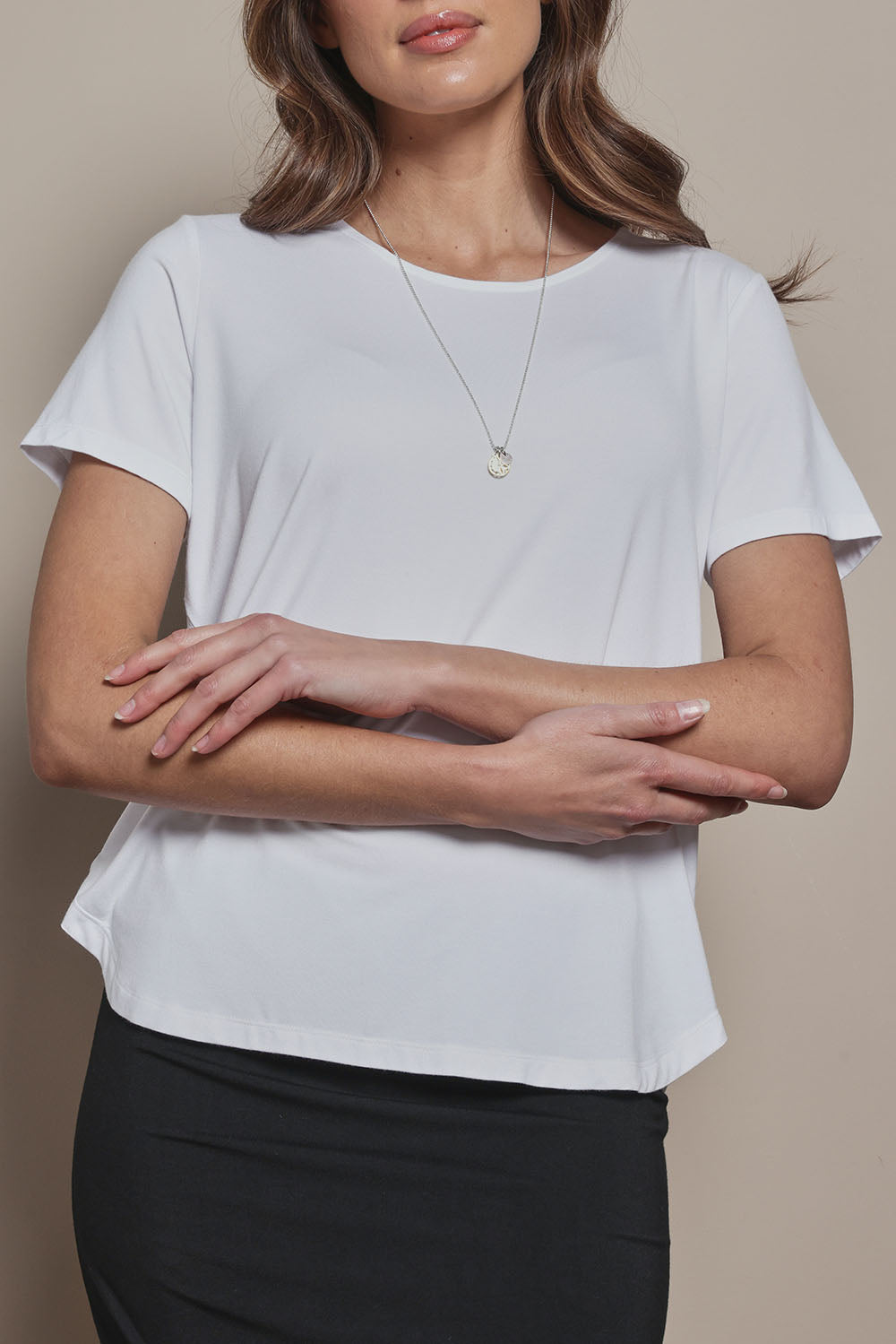 Model Madeline wearing size 10 of The Pack & Go Luxe Bamboo Tee in colour White (White), from the front, cropped image