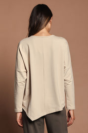 Model Madeline wearing size 10 of The Cotton Comfort Asymmetric Tee in colour Almond, from the back