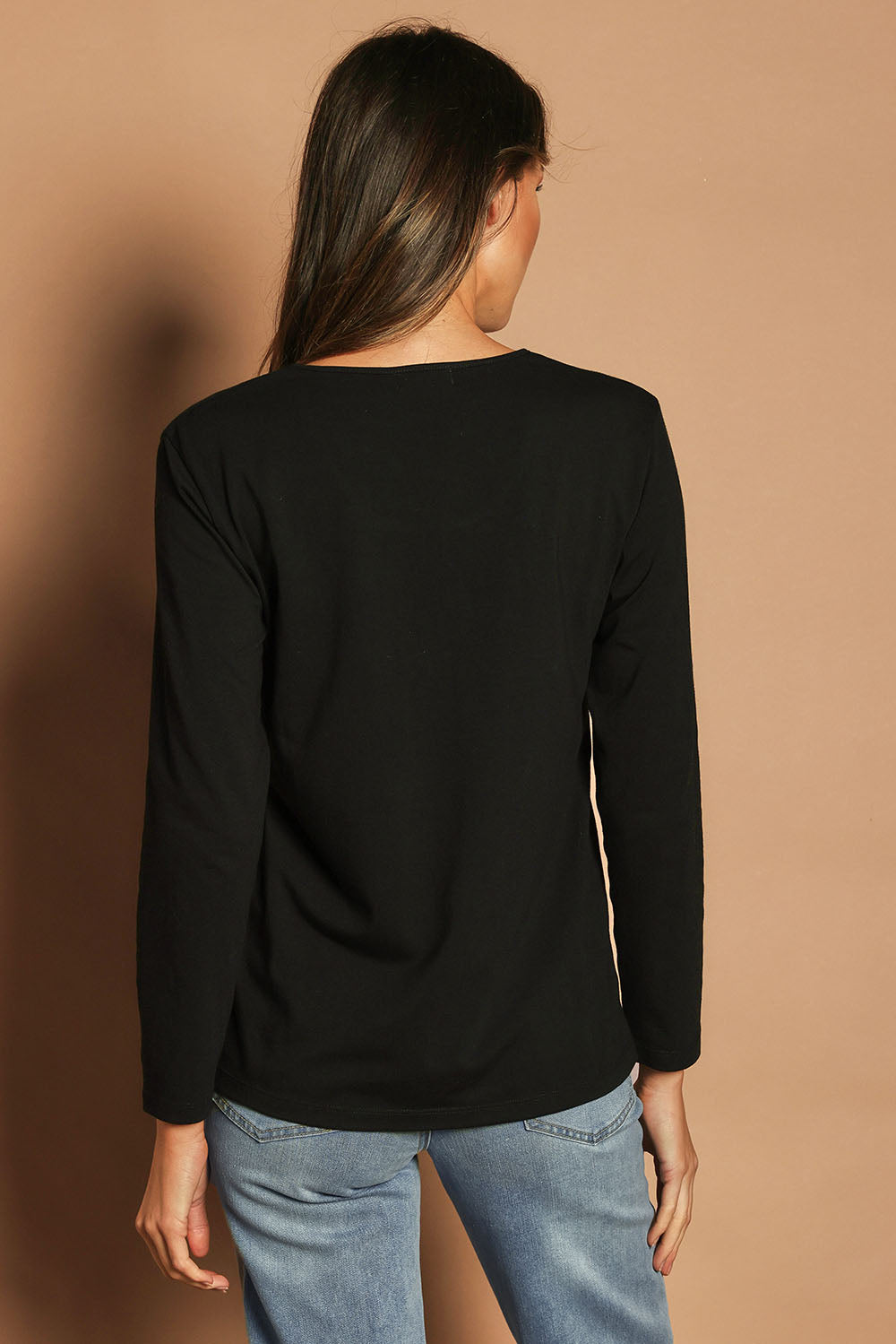 Model Madeline wearing size 10 of The Classic Long Sleeve Tee in colour Black (Black), from the back