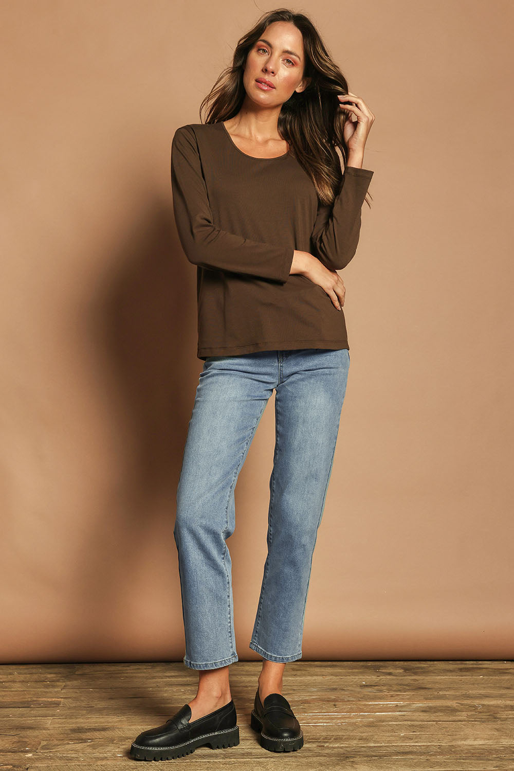 Model Madeline wearing size 10 of The Classic Long Sleeve Tee in colour Cocoa, from the front, showing the whole outfit