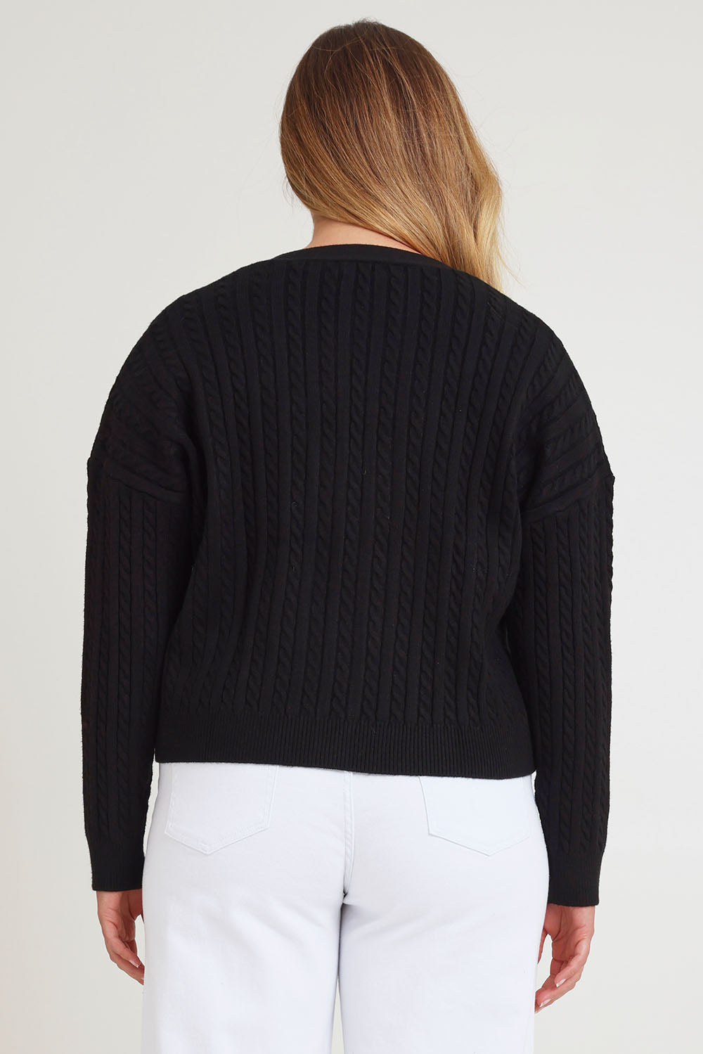 Model Chanel wearing size XL of The Cable Knit Button Up Cardigan in colour Black (Black), from the back
